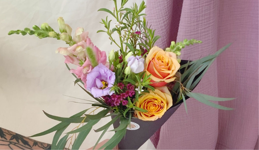 bouquet of orange, purple, and pink flowers by Bagel's Florals in Albuquerque, New Mexico